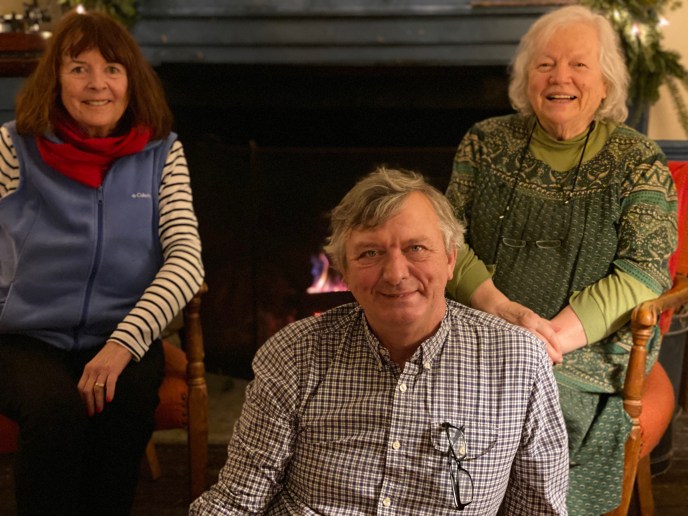 Robyn and Jeff Skramstad and Jean Boardman by the fire